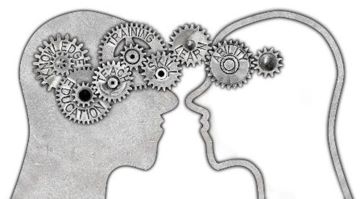 grey and white drawing of two heads facing each other with cogs moving between them to represent the reflective nature of the supervision relationship.