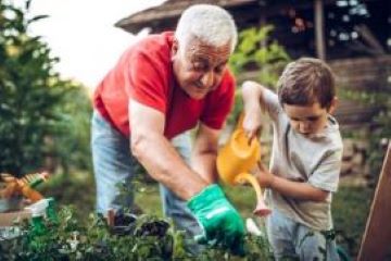 A man and child watering a garden to symbolises the need to maintain mental health and wellbeing.