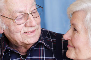 A close up of a man and a woman looking at each other.